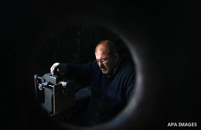A Palestinian copper, Mohammed Abdo 56, works at his workshop, in Gaza city, on February 21, 2018. Abdo inherited copper profession from his father for nearly 40 years. Make replicas Crescent attached to mosques. He is t...