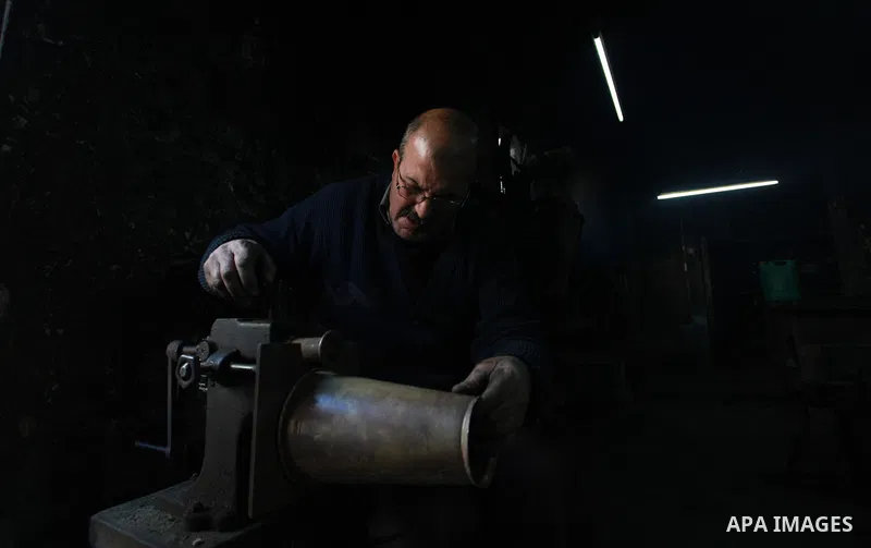 A Palestinian copper, Mohammed Abdo 56, works at his workshop, in Gaza city, on February 21, 2018. Abdo inherited copper profession from his father for nearly 40 years. Make replicas Crescent attached to mosques. He is t...