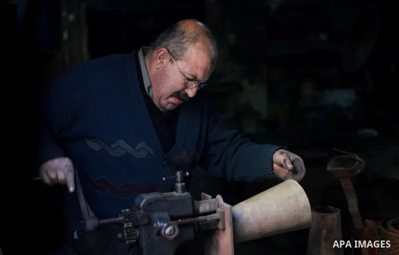 A Palestinian copper, Mohammed Abdo 56, works at his workshop, in Gaza city, on February 21, 2018. Abdo inherited copper profession from his father for nearly 40 years. Make replicas Crescent attached to mosques. He is t...