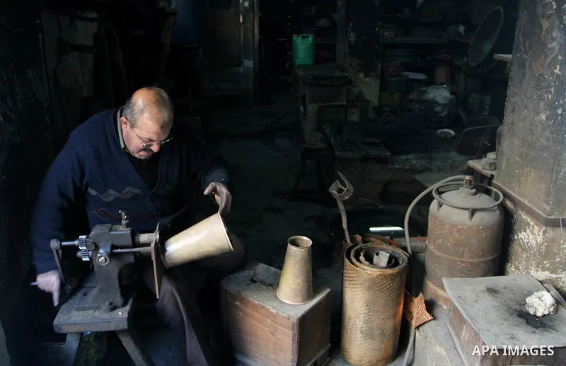 A Palestinian copper, Mohammed Abdo 56, works at his workshop, in Gaza city, on February 21, 2018. Abdo inherited copper profession from his father for nearly 40 years. Make replicas Crescent attached to mosques. He is t...
