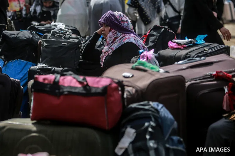 Palestinians wait for permission to cross into Egypt through the Rafah border crossing in the southern Gaza Strip after it was opened by Egyptian authorities on February 21, 2018. Both Israel and Egypt have maintained bl...
