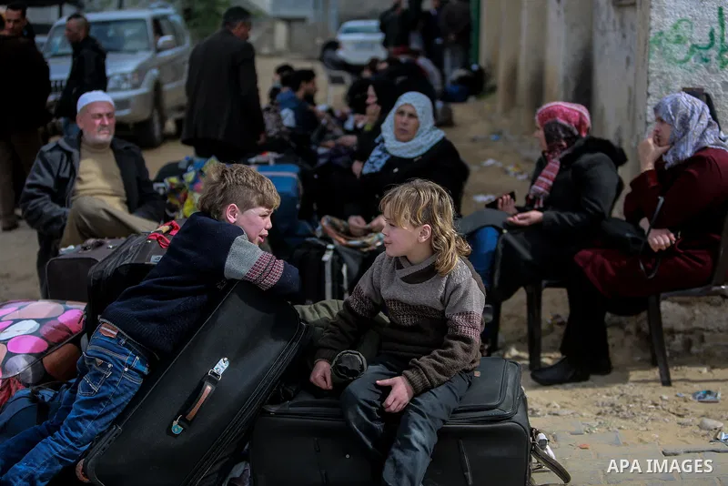 Palestinians wait for permission to cross into Egypt through the Rafah border crossing in the southern Gaza Strip after it was opened by Egyptian authorities on February 21, 2018. Both Israel and Egypt have maintained bl...