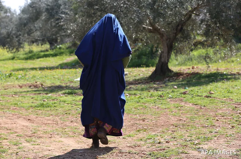 An elderly Palestinian woman Sobha Kassab 77, wears a traditional cloak or "Abaya" outside her house in the West Bank village of Qaryut, near Nablus on February 21, 2018. Decades ago, the cloack or "Abaya" was common for...