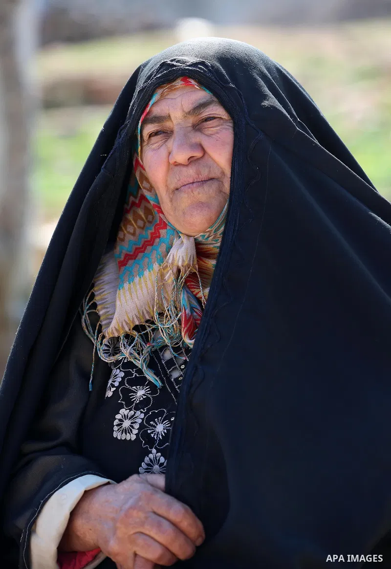 An elderly Palestinian woman Nada Auda 62, wears a traditional cloak or "Abaya" outside her house in the West Bank village of Qusra, near Nablus on February 21, 2018. Decades ago, the cloack or "Abaya" was common for vil...