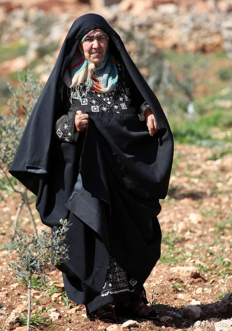 An elderly Palestinian woman Nada Auda 62, wears a traditional cloak or "Abaya" outside her house in the West Bank village of Qusra, near Nablus on February 21, 2018. Decades ago, the cloack or "Abaya" was common for vil...