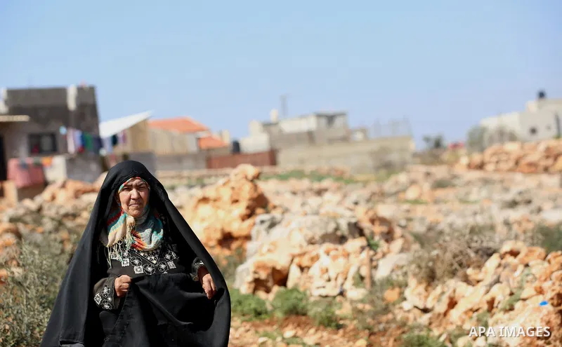 An elderly Palestinian woman Nada Auda 62, wears a traditional cloak or "Abaya" outside her house in the West Bank village of Qusra, near Nablus on February 21, 2018. Decades ago, the cloack or "Abaya" was common for vil...