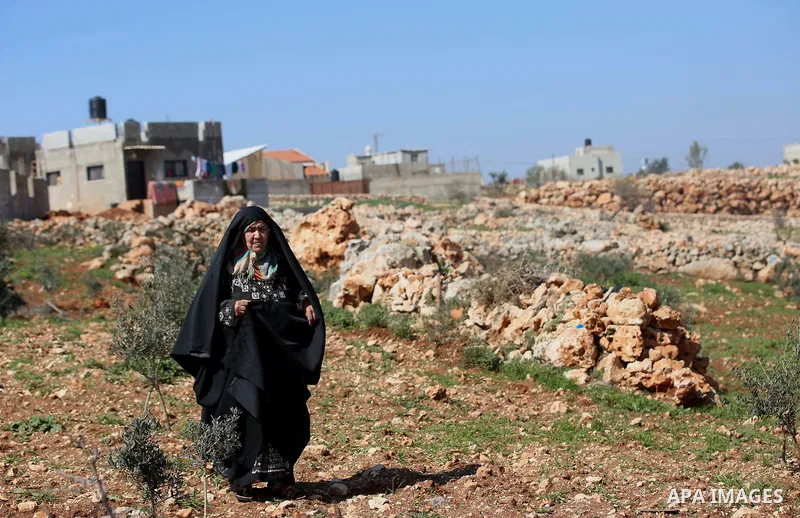 An elderly Palestinian woman Nada Auda 62, wears a traditional cloak or "Abaya" outside her house in the West Bank village of Qusra, near Nablus on February 21, 2018. Decades ago, the cloack or "Abaya" was common for vil...