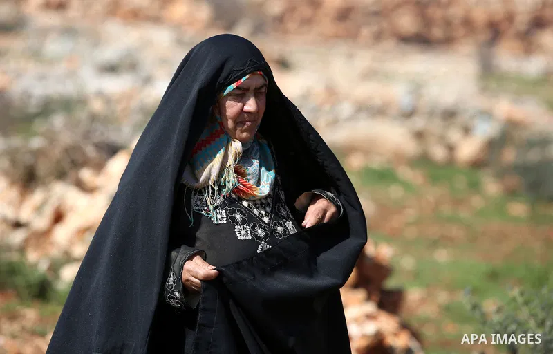 An elderly Palestinian woman Nada Auda 62, wears a traditional cloak or "Abaya" outside her house in the West Bank village of Qusra, near Nablus on February 21, 2018. Decades ago, the cloack or "Abaya" was common for vil...