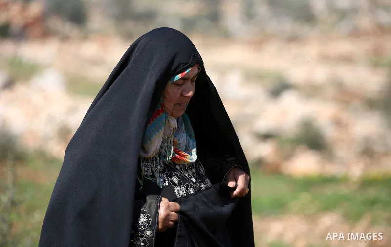 An elderly Palestinian woman Nada Auda 62, wears a traditional cloak or "Abaya" outside her house in the West Bank village of Qusra, near Nablus on February 21, 2018. Decades ago, the cloack or "Abaya" was common for vil...