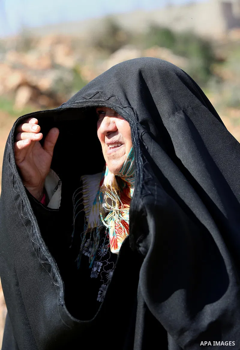 An elderly Palestinian woman Nada Auda 62, wears a traditional cloak or "Abaya" outside her house in the West Bank village of Qusra, near Nablus on February 21, 2018. Decades ago, the cloack or "Abaya" was common for vil...