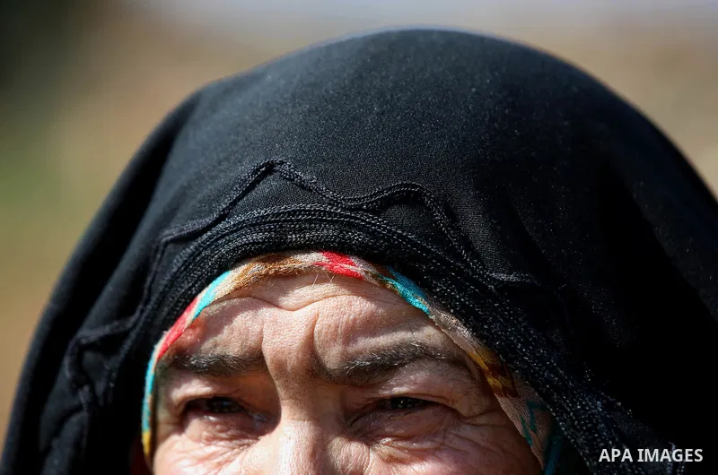An elderly Palestinian woman Nada Auda 62, wears a traditional cloak or "Abaya" outside her house in the West Bank village of Qusra, near Nablus on February 21, 2018. Decades ago, the cloack or "Abaya" was common for vil...