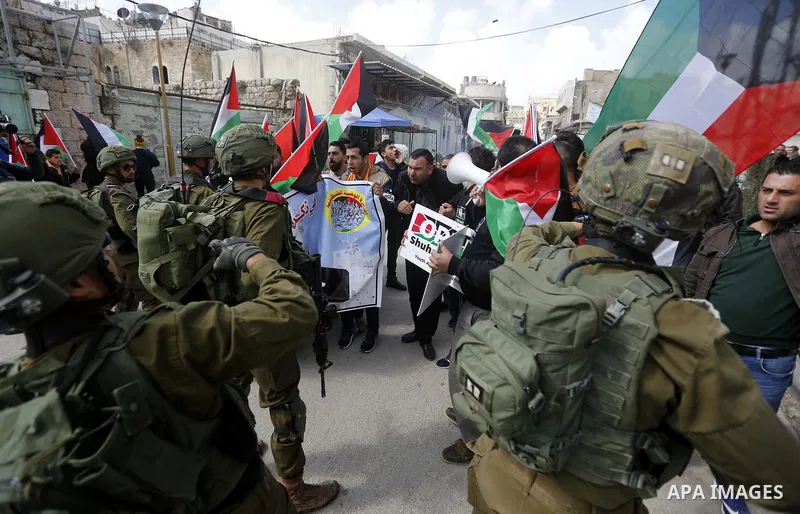 Palestinians clash with Israeli troops following a demonstration against the closure of Shuhada street, on the 24th anniversary of the closure, on February 23, 2018 in the West Bank city of Hebron. On February 25, 1994 I...