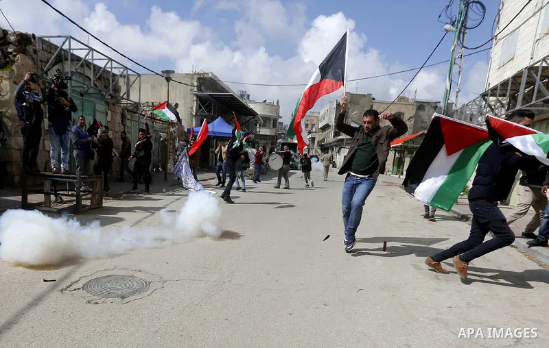 Palestinians clash with Israeli troops following a demonstration against the closure of Shuhada street, on the 24th anniversary of the closure, on February 23, 2018 in the West Bank city of Hebron. On February 25, 1994 I...