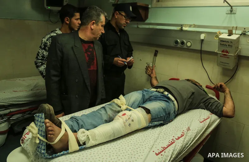 An injured Palestinian protester, who was wounded during clashes with the Israeli army along the Gaza border, recieves treatment at al-Shifa hospital in Gaza City on February 23, 2018. Photo by Dawoud Abo Alkas