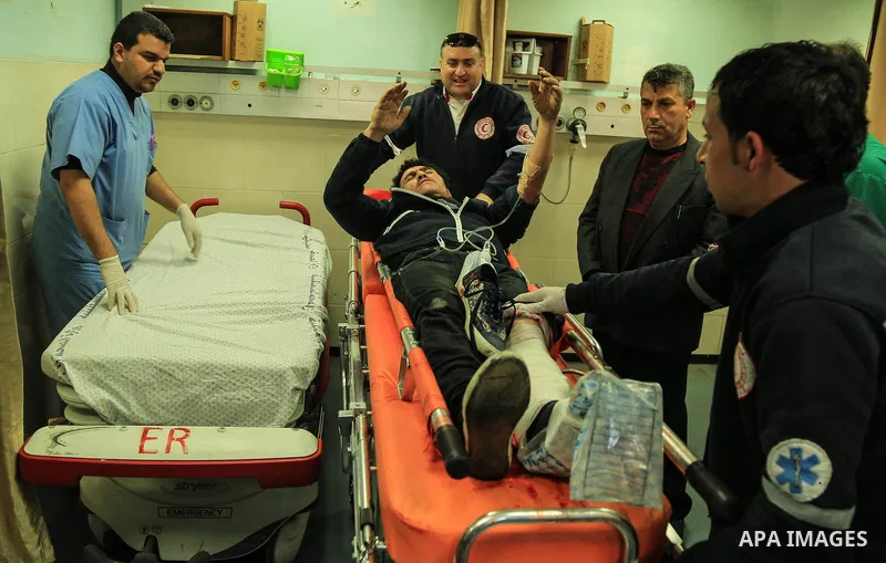 An injured Palestinian protester, who was wounded during clashes with the Israeli army along the Gaza border, recieves treatment at al-Shifa hospital in Gaza City on February 23, 2018. Photo by Dawoud Abo Alkas