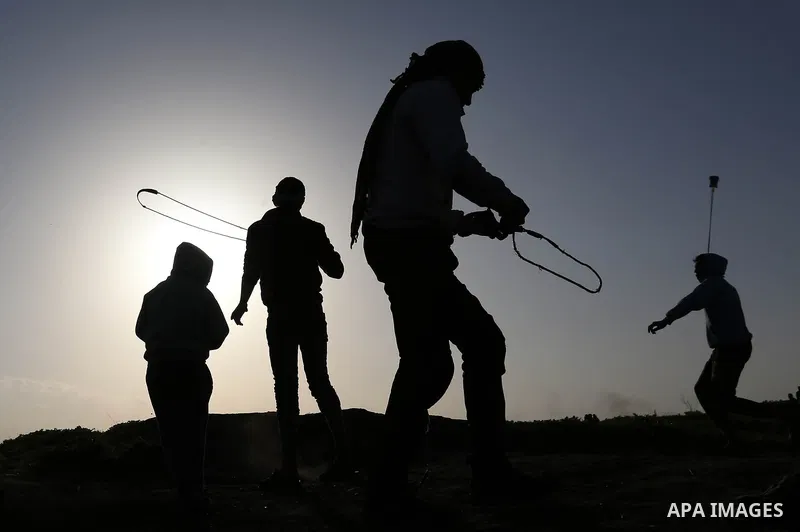 Palestinian protesters clash with Israeli security forces near the border fence with Israel, east of Gaza City on February 23, 2018. Photo by Ashraf Amra