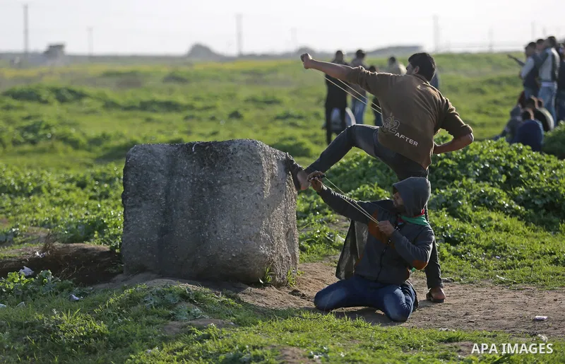 Palestinian protesters clash with Israeli security forces near the border fence with Israel, east of Gaza City on February 23, 2018. Photo by Ashraf Amra