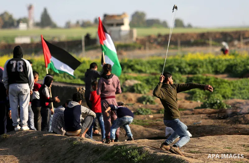 Palestinian protesters clash with Israeli security forces near the border fence with Israel, east of Gaza City on February 23, 2018. Photo by Ashraf Amra