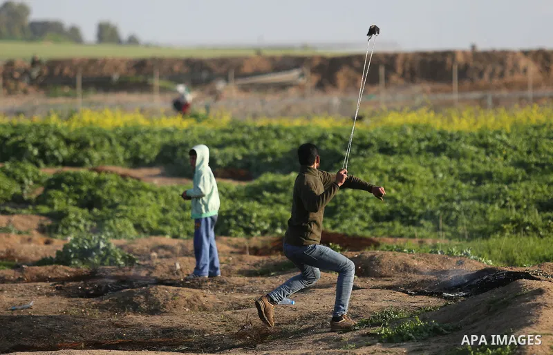 Palestinian protesters clash with Israeli security forces near the border fence with Israel, east of Gaza City on February 23, 2018. Photo by Ashraf Amra