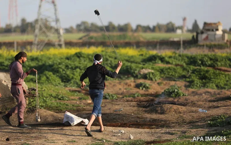 Palestinian protesters clash with Israeli security forces near the border fence with Israel, east of Gaza City on February 23, 2018. Photo by Ashraf Amra