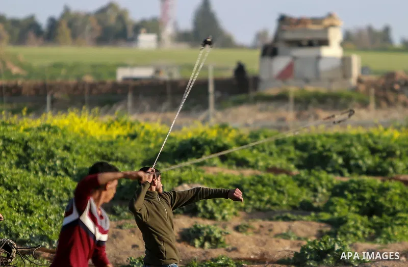 Palestinian protesters clash with Israeli security forces near the border fence with Israel, east of Gaza City on February 23, 2018. Photo by Mohammed Dahman