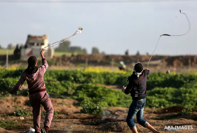 Palestinian protesters clash with Israeli security forces near the border fence with Israel, east of Gaza City on February 23, 2018. Photo by Mohammed Dahman
