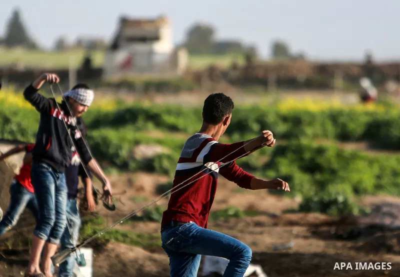 Palestinian protesters clash with Israeli security forces near the border fence with Israel, east of Gaza City on February 23, 2018. Photo by Mohammed Dahman