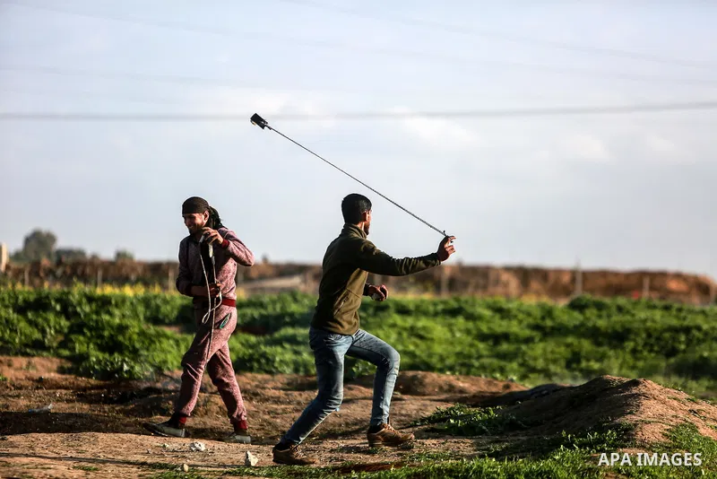 Palestinian protesters clash with Israeli security forces near the border fence with Israel, east of Gaza City on February 23, 2018. Photo by Mohammed Dahman