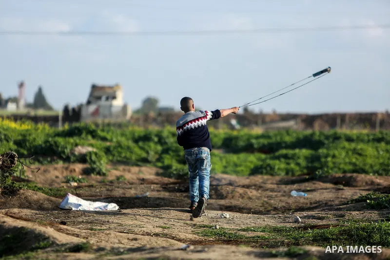 Palestinian protesters clash with Israeli security forces near the border fence with Israel, east of Gaza City on February 23, 2018. Photo by Mohammed Dahman