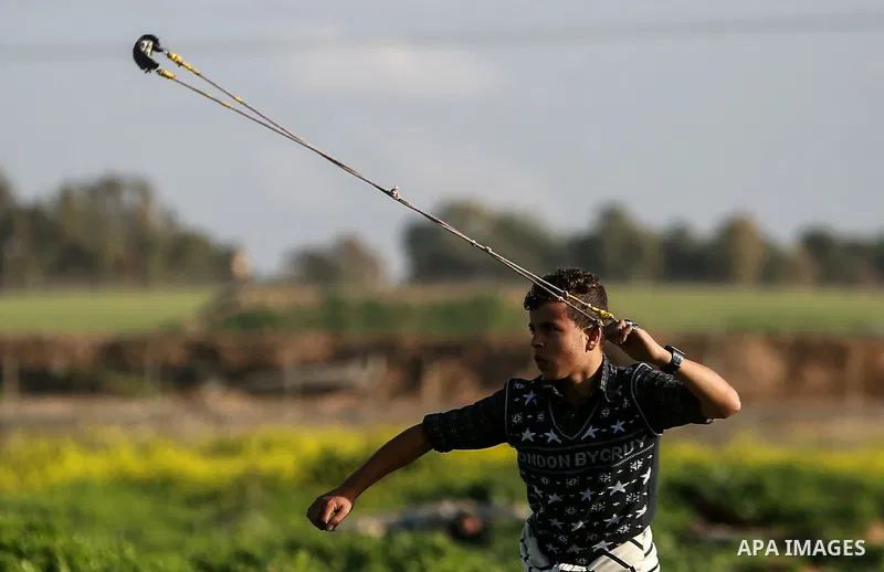 Palestinian protesters clash with Israeli security forces near the border fence with Israel, east of Gaza City on February 23, 2018. Photo by Mohammed Dahman