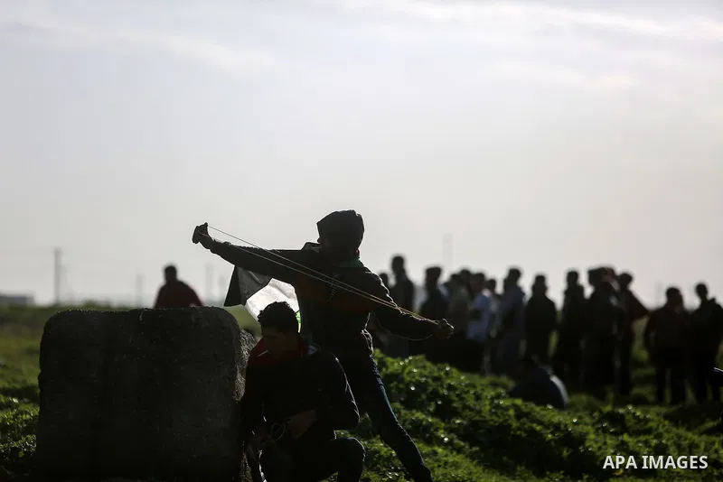 Palestinian protesters clash with Israeli security forces near the border fence with Israel, east of Gaza City on February 23, 2018. Photo by Mohammed Dahman
