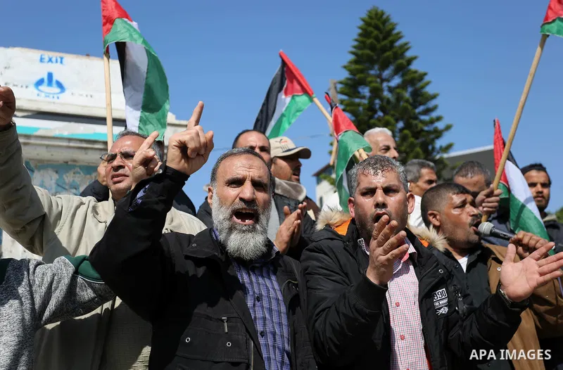 Palestinians wave national flag and shout slogans during a protest against U.S. President Donald Trump's decision to recognise Jerusalem as the capital of Israel in Gaza city on February, 24, 2018. Photo by Ashraf Amra