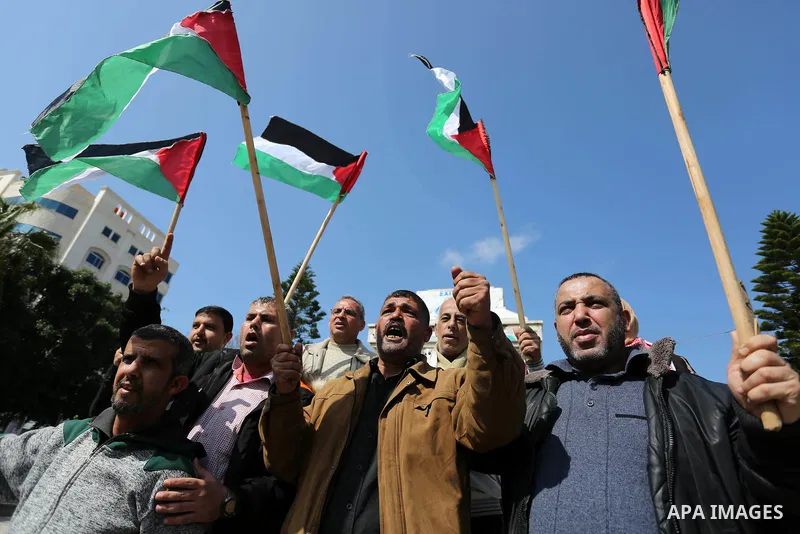 Palestinians wave national flag and shout slogans during a protest against U.S. President Donald Trump's decision to recognise Jerusalem as the capital of Israel in Gaza city on February, 24, 2018. Photo by Ashraf Amra