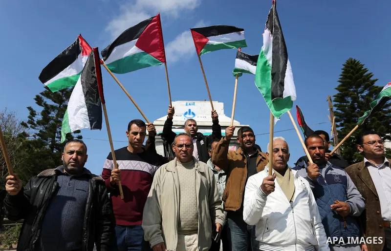 Palestinians wave national flag and shout slogans during a protest against U.S. President Donald Trump's decision to recognise Jerusalem as the capital of Israel in Gaza city on February, 24, 2018. Photo by Ashraf Amra