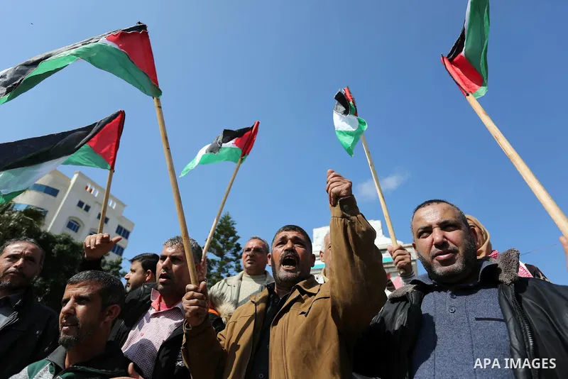 Palestinians wave national flag and shout slogans during a protest against U.S. President Donald Trump's decision to recognise Jerusalem as the capital of Israel in Gaza city on February, 24, 2018. Photo by Ashraf Amra