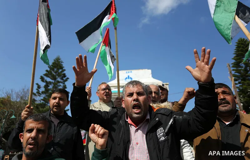 Palestinians wave national flag and shout slogans during a protest against U.S. President Donald Trump's decision to recognise Jerusalem as the capital of Israel in Gaza city on February, 24, 2018. Photo by Ashraf Amra