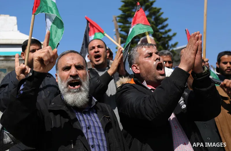 Palestinians wave national flag and shout slogans during a protest against U.S. President Donald Trump's decision to recognise Jerusalem as the capital of Israel in Gaza city on February, 24, 2018. Photo by Ashraf Amra