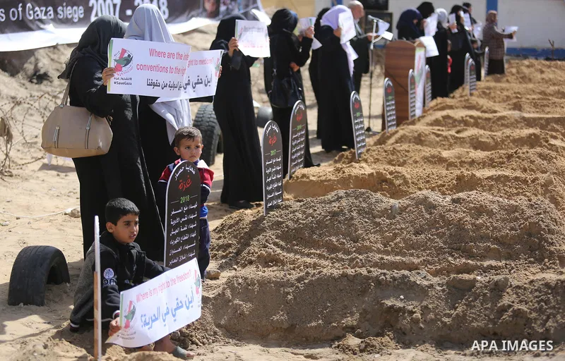 Palestinian women hold banners during a protest against the siege on the Gaza Strip in Gaza City on February 25, 2018. Israel has maintained a siege on Gaza for a decade which it says is necessary to limit Hamas, the Isl...