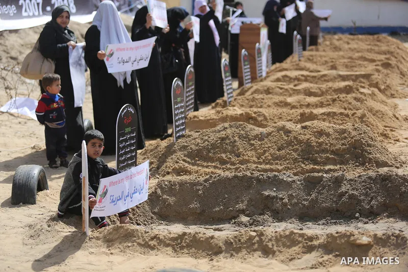 Palestinian women hold banners during a protest against the siege on the Gaza Strip in Gaza City on February 25, 2018. Israel has maintained a siege on Gaza for a decade which it says is necessary to limit Hamas, the Isl...