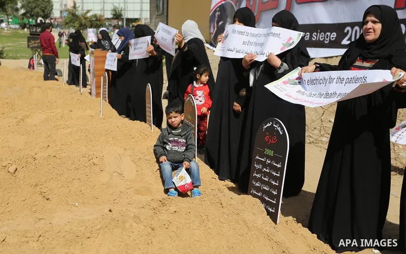 Palestinian women hold banners during a protest against the siege on the Gaza Strip in Gaza City on February 25, 2018. Israel has maintained a siege on Gaza for a decade which it says is necessary to limit Hamas, the Isl...