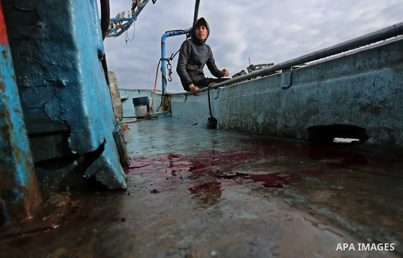 A Palestinian man inspects a boat at the port in Gaza City on February 26, 2018 in which a fisherman was killed when Israeli forces opened fire on it the previous day. A spokeswoman for the Israeli army said the boat "de...