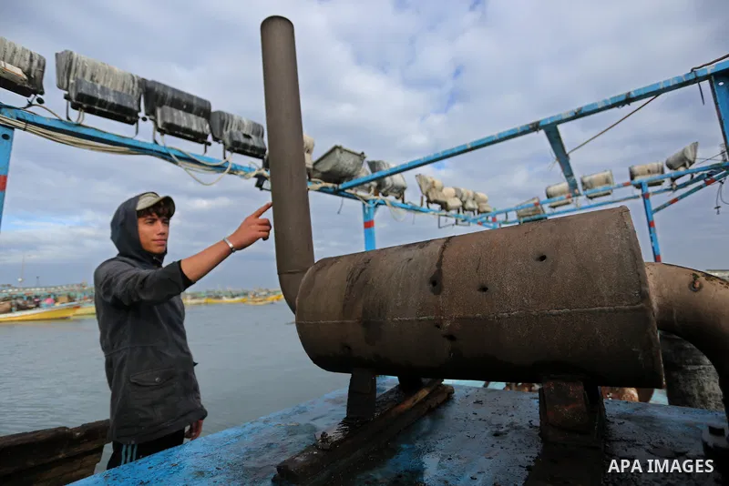 A Palestinian man inspects a boat at the port in Gaza City on February 26, 2018 in which a fisherman was killed when Israeli forces opened fire on it the previous day. A spokeswoman for the Israeli army said the boat "de...