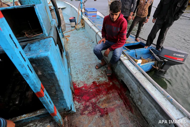 A Palestinian man inspects a boat at the port in Gaza City on February 26, 2018 in which a fisherman was killed when Israeli forces opened fire on it the previous day. A spokeswoman for the Israeli army said the boat "de...