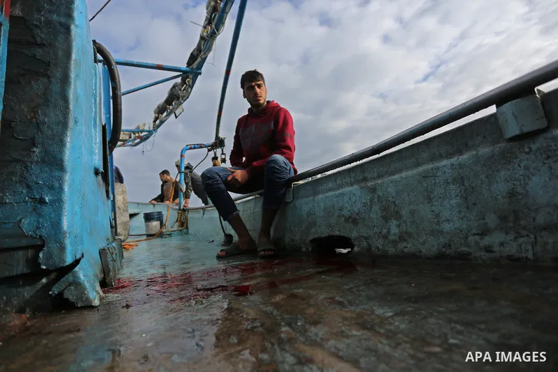 A Palestinian man inspects a boat at the port in Gaza City on February 26, 2018 in which a fisherman was killed when Israeli forces opened fire on it the previous day. A spokeswoman for the Israeli army said the boat "de...