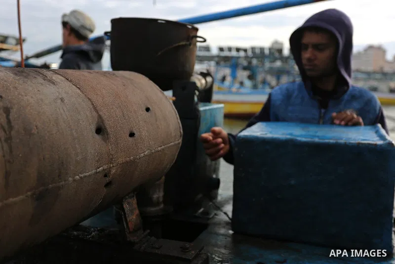 A Palestinian man inspects a boat at the port in Gaza City on February 26, 2018 in which a fisherman was killed when Israeli forces opened fire on it the previous day. A spokeswoman for the Israeli army said the boat "de...