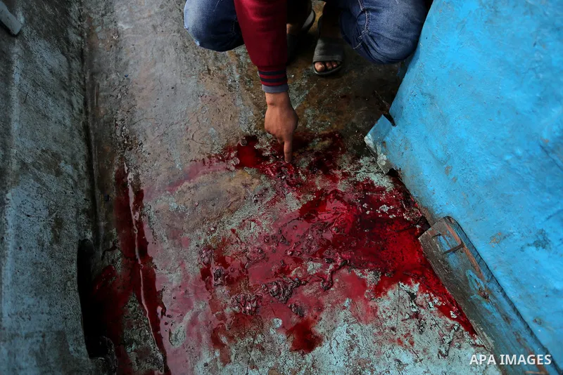 A Palestinian man inspects a boat at the port in Gaza City on February 26, 2018 in which a fisherman was killed when Israeli forces opened fire on it the previous day. A spokeswoman for the Israeli army said the boat "de...