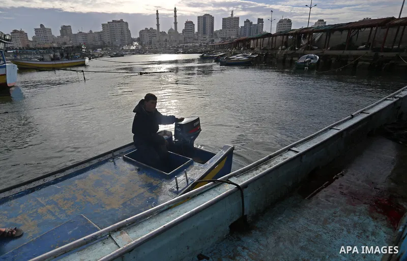 A Palestinian man inspects a boat at the port in Gaza City on February 26, 2018 in which a fisherman was killed when Israeli forces opened fire on it the previous day. A spokeswoman for the Israeli army said the boat "de...