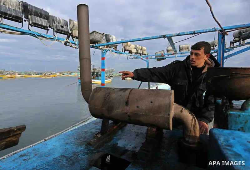A Palestinian man inspects a boat at the port in Gaza City on February 26, 2018 in which a fisherman was killed when Israeli forces opened fire on it the previous day. A spokeswoman for the Israeli army said the boat "de...