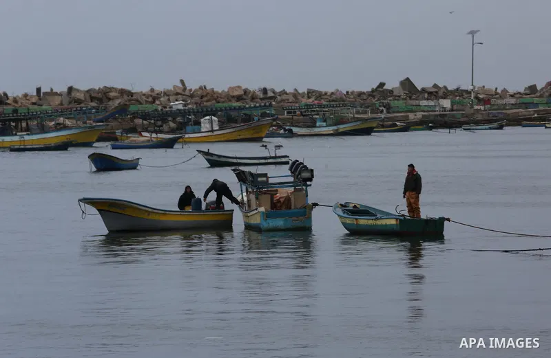 Palestinian fishermen work on their fishing boats at the port in Gaza City on February 26, 2018. A spokeswoman for the Israeli army said the boat "deviated from the designated fishing zone in the northern Gaza Strip. "Na...