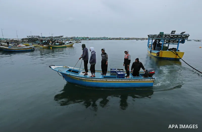 Palestinian fishermen work on their fishing boats at the port in Gaza City on February 26, 2018. A spokeswoman for the Israeli army said the boat "deviated from the designated fishing zone in the northern Gaza Strip. "Na...